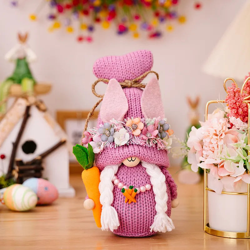 Pink Easter gnome with bunny ears, carrot, and floral crown.