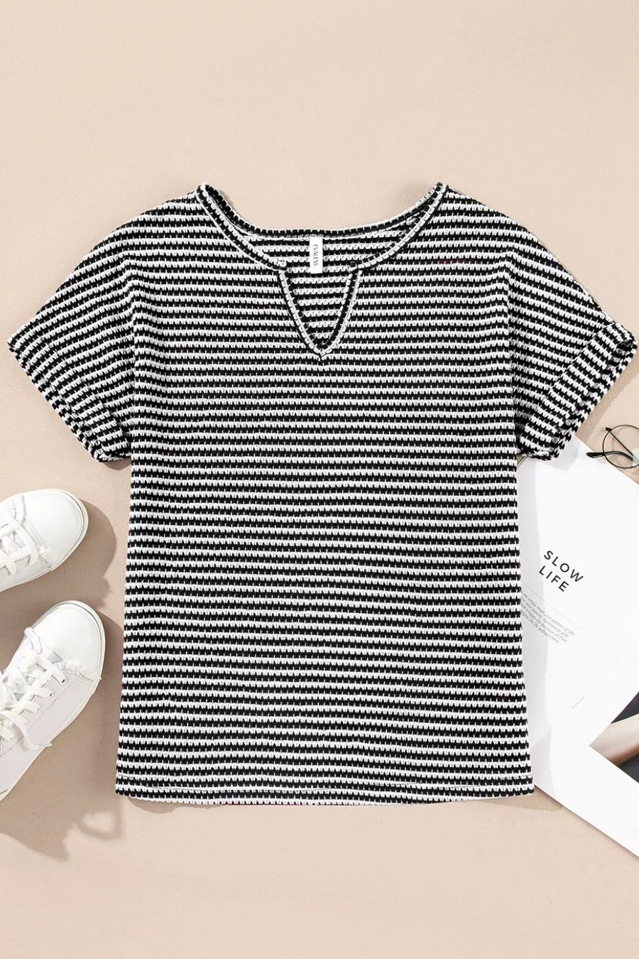 Textured knit t-shirt with horizontal stripes and a notched neckline.