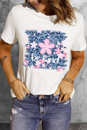 White graphic tee with floral accents and "be kind" text