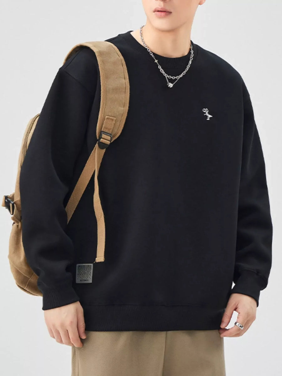 Black crewneck sweatshirt with embroidered dinosaur detail, long sleeves, and comfortable fit.