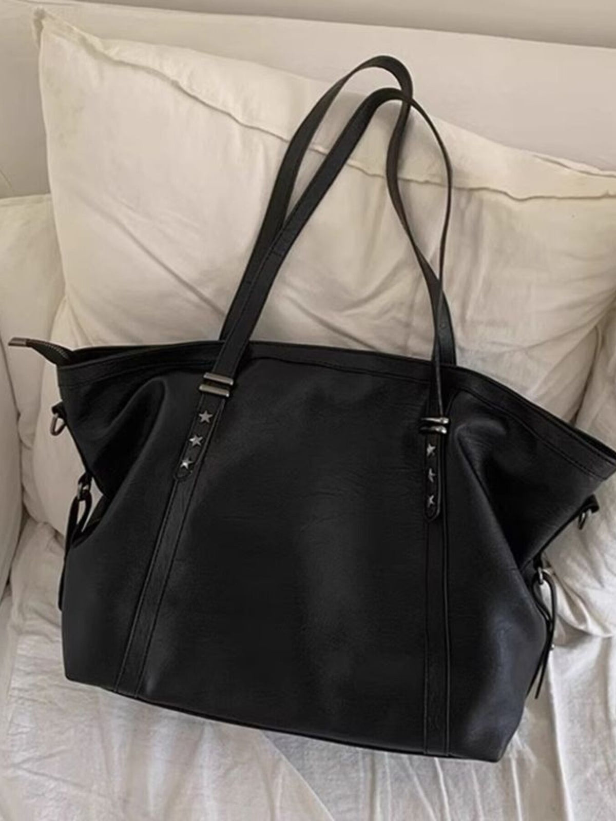 Black pu leather tote bag with star stud details and double straps.