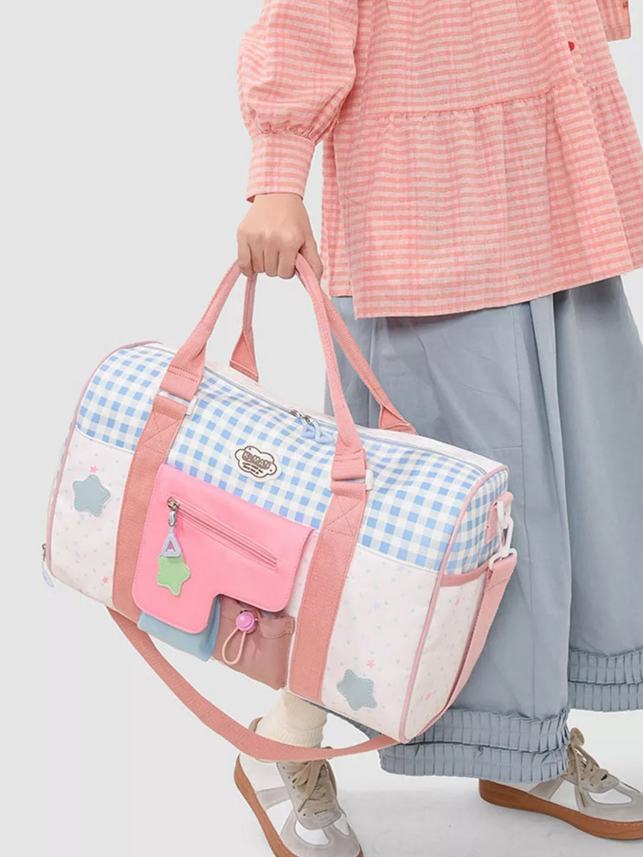 Charming color block travel bag with blue gingham, stars, and pink pockets.