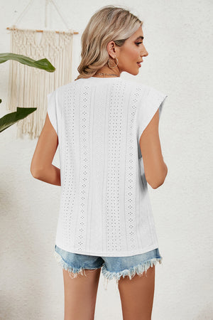 White perforated shoulder-pad top with cap sleeves and a relaxed fit.