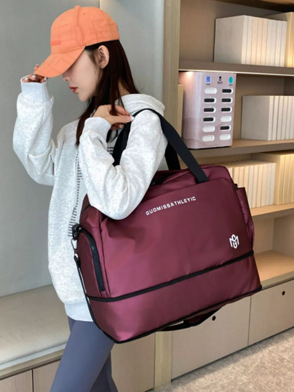Wine red Oxford cloth travel duffle bag with adjustable strap and dual compartments.