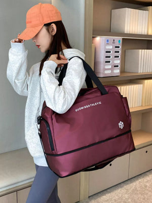 Wine red Oxford cloth travel duffle bag with adjustable strap and dual compartments.