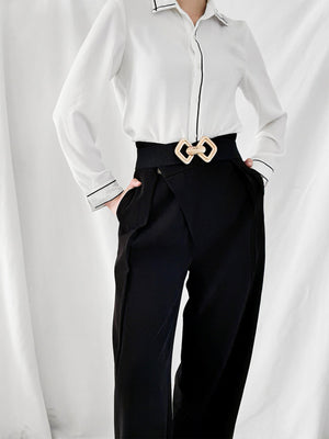 Black elasticated waist belt with gold geometric buckle detail