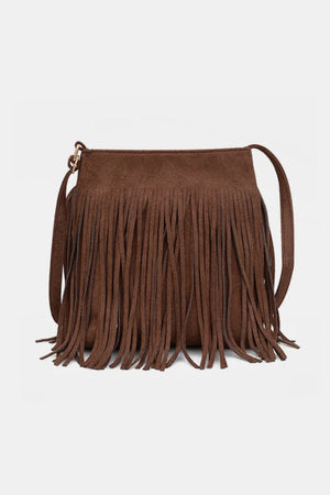Brown suede crossbody bag with long fringe detail and adjustable strap.