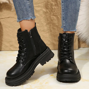 Black combat boots with side zip detail and lace-up front on a platform sole.