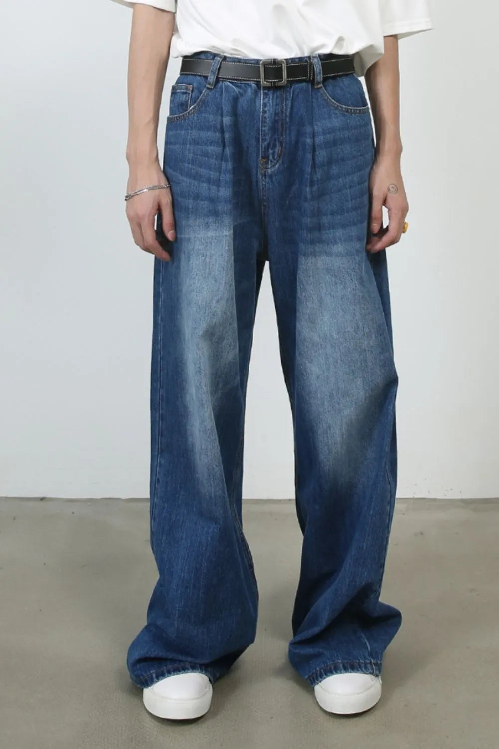 Pleated-front wide-leg denim trousers in peacock blue with a relaxed fit.