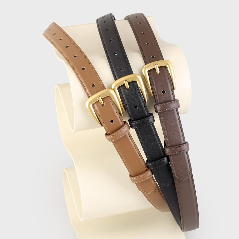 Skinny leather belts in black, brown, and olive brown with golden buckles.
