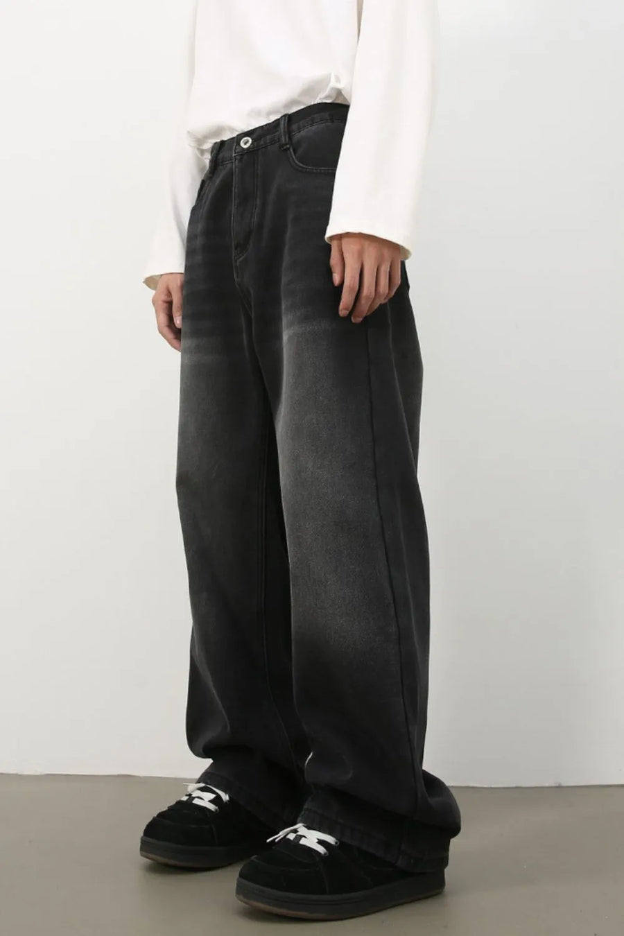 Oversized fade wash denim jeans in dark, wide leg, casual fit.