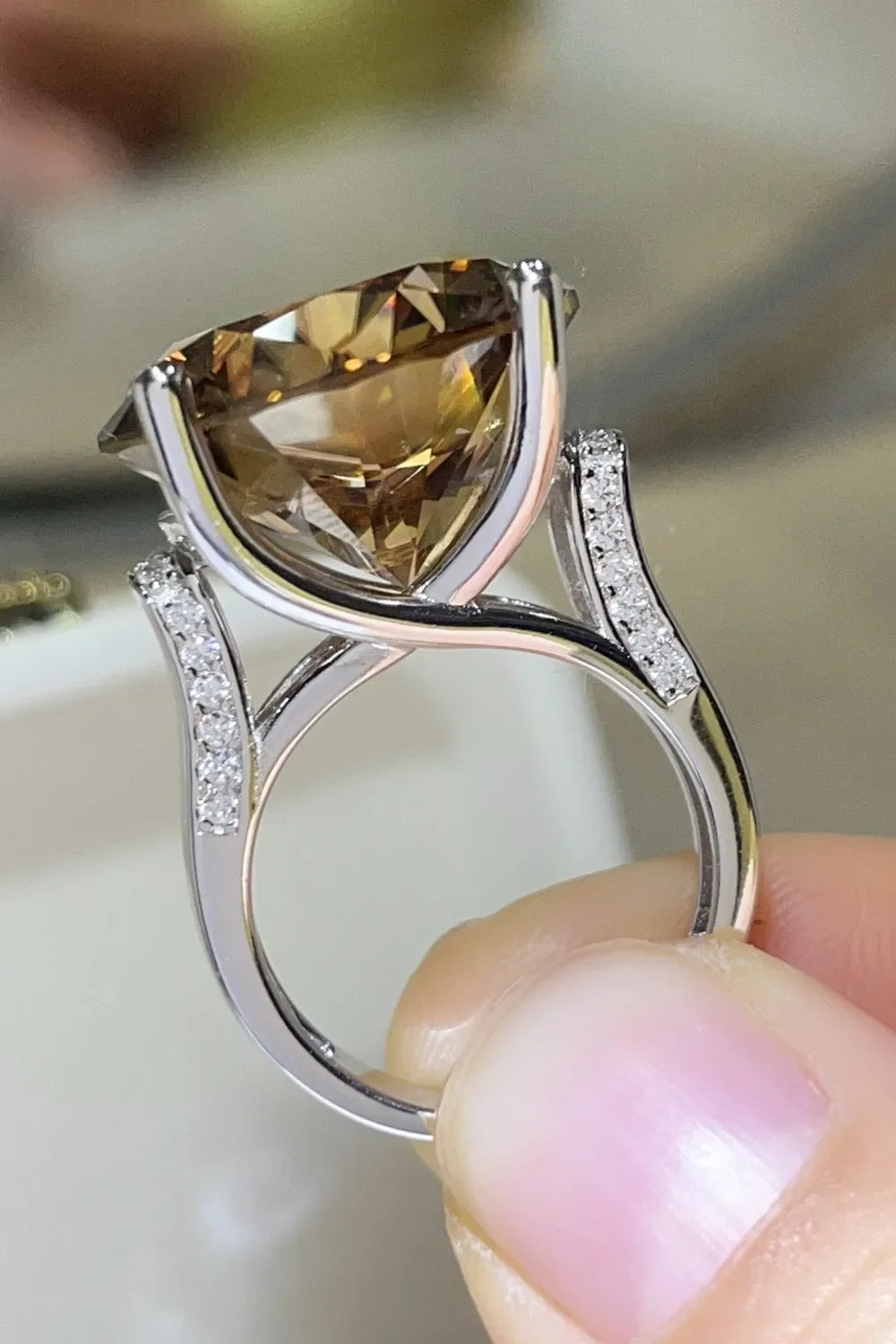Radiant cut moissanite cocktail ring in gold with diamond accents.