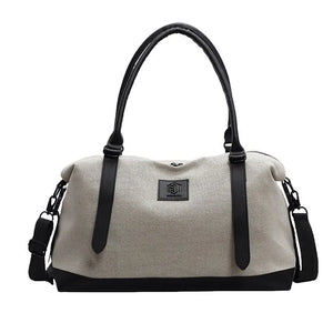 Canvas weekend holdall duffel bag in Khaki with black trim and straps, featuring a logo patch.