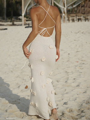 Beige knit maxi dress with 3D floral appliques and a crisscross back.