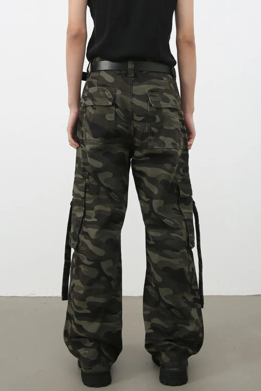 Wide-leg camo cargo pants with belt detail and multiple pockets.