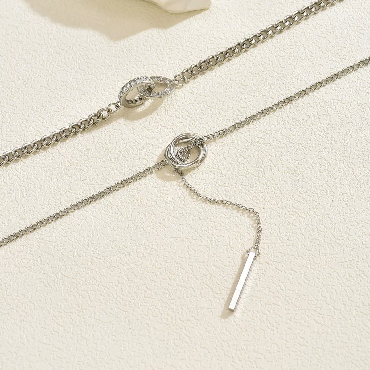 Silver layered Y-shaped pendant necklace with interlocking rings and bar detail