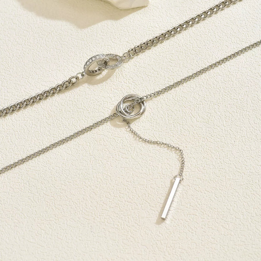 Silver layered Y-shaped pendant necklace with interlocking rings and bar detail