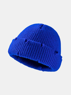 Royal blue ribbed knit beanie with distressed details and a cuffed brim.