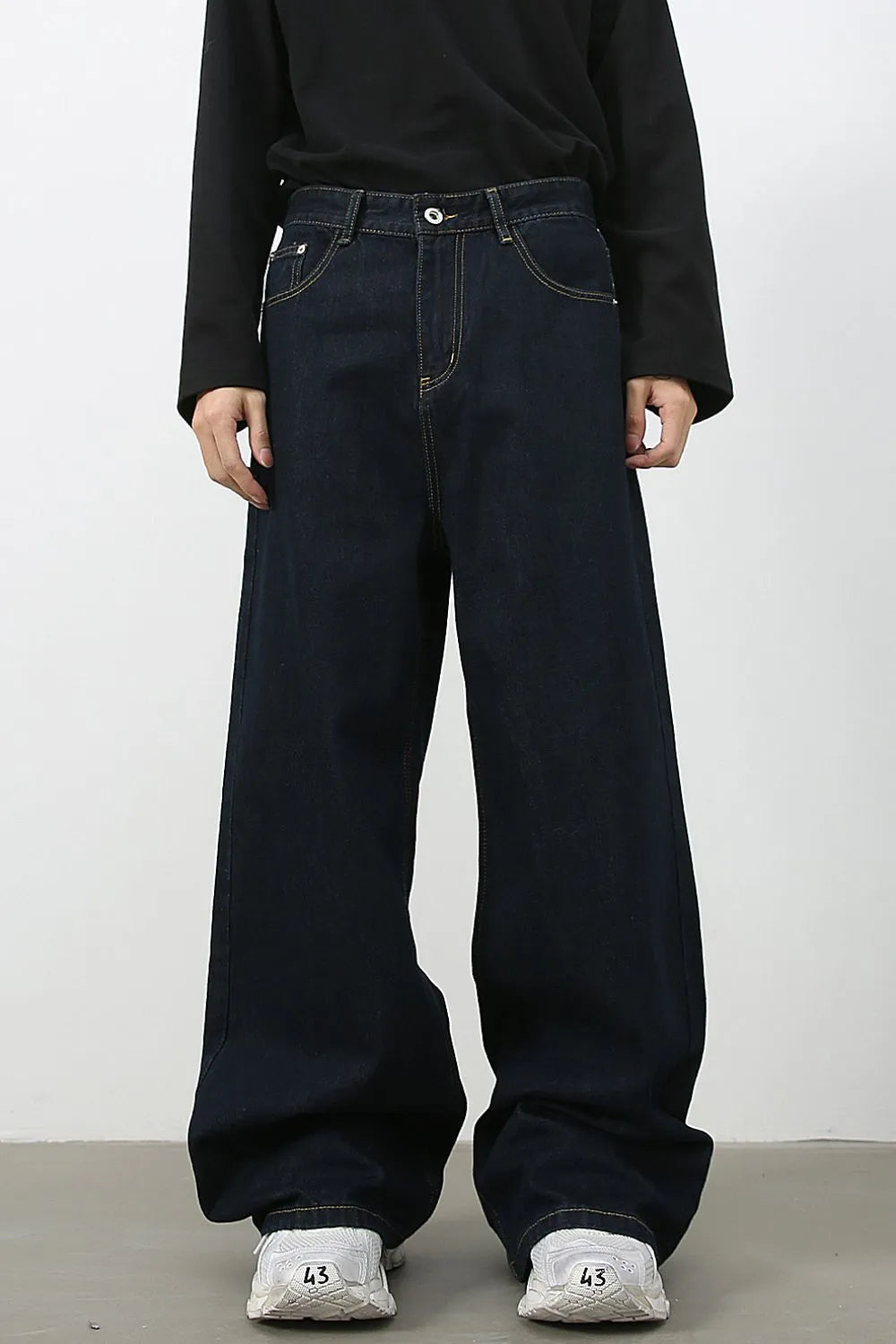 Dark denim exaggerated wide leg jeans with yellow stitching.