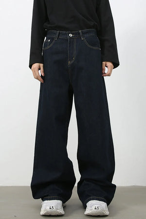 Dark denim exaggerated wide leg jeans with yellow stitching.