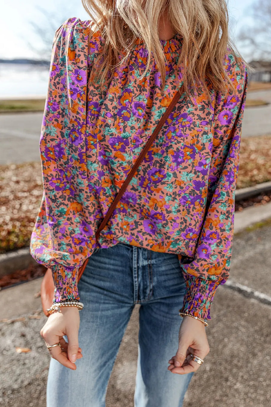 Purple floral print blouse with gathered sleeves and mock neck.