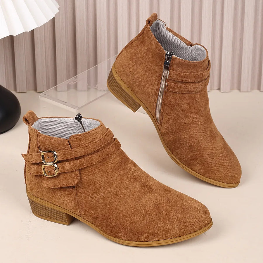 Ochre suede ankle booties with double buckle detail and side zipper.