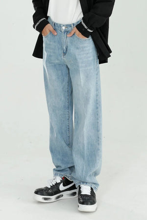 Relaxed fit light wash denim jeans with a wide leg, styled casually.