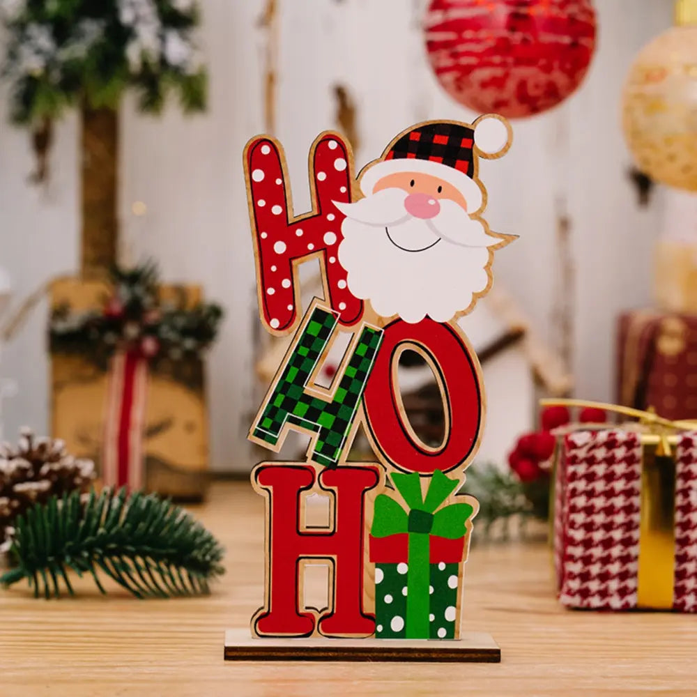 Wooden holiday decor trio with Santa, red and green letters, and gift box.