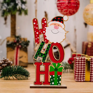 Wooden holiday decor trio with Santa, red and green letters, and gift box.