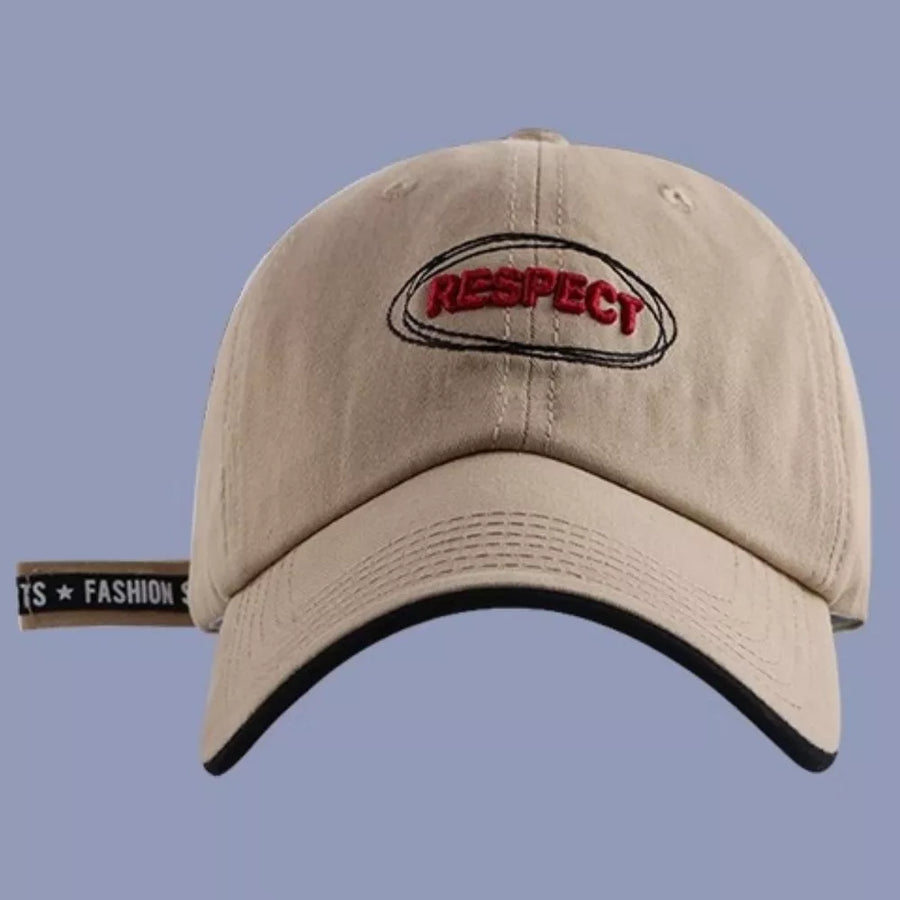 Khaki baseball cap with embroidered "RESPECT" detail and black brim trim.