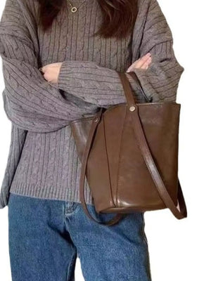 Elegant coffee brown PU leather bucket bag with a simple design and thin strap.