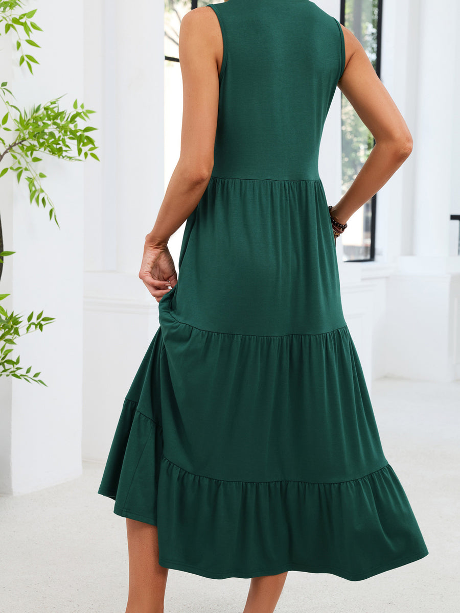 Dark green tiered midi dress with a notched V-neck and sleeveless design.