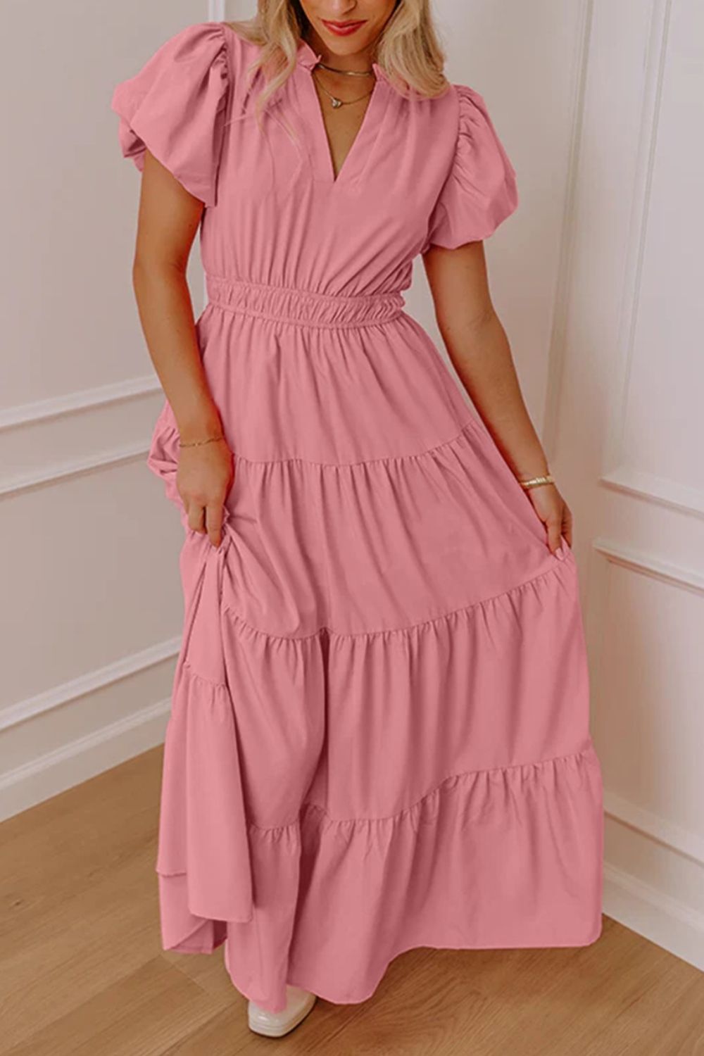 Dusty pink maxi dress with puff sleeves, V-neck, and tiered skirt.