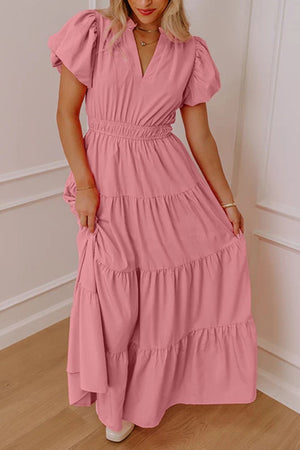Dusty pink maxi dress with puff sleeves, V-neck, and tiered skirt.