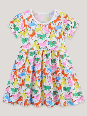 Toddler cotton dress with playful multi-color horse print, puff sleeves, and gathered waist.