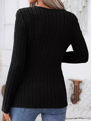 Black ribbed knit long sleeve top with notched neckline detail.