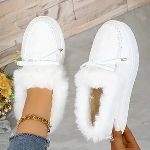 White suede loafers with shearling trim and bow detail