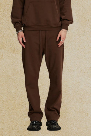 Relaxed fit brown joggers with drawstring waist and cuffed ankles.