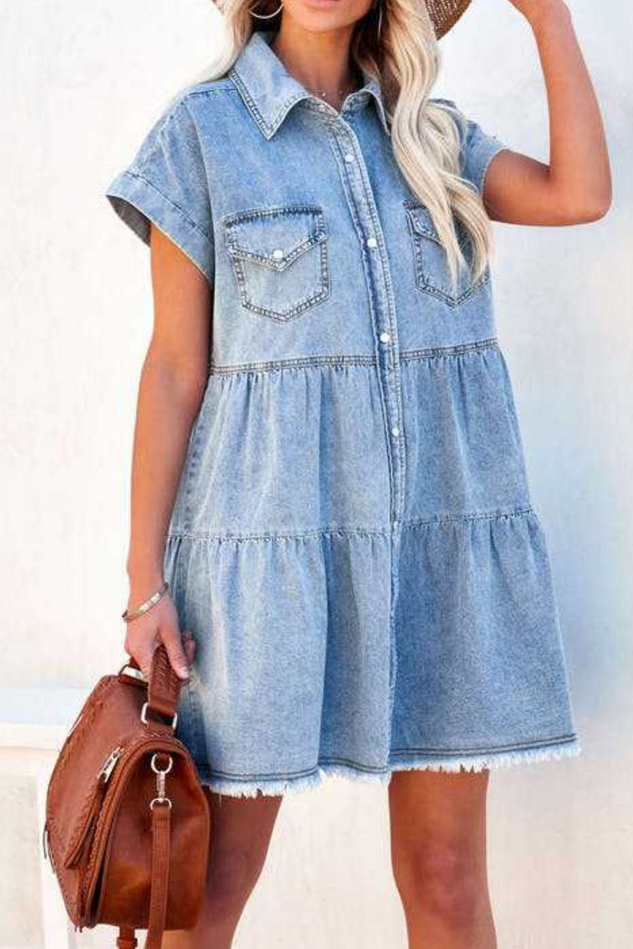 Tiered light blue denim shirtdress with frayed hem and short sleeves.