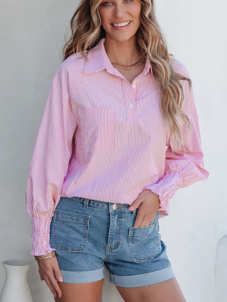 Pink and white striped collared long sleeve shirt with smocked cuffs and a button placket.