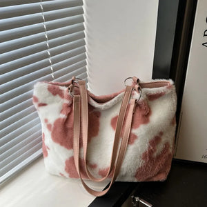 Dusty pink cowhide print faux fur shopper bag with leather straps.