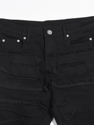 Black denim jeans with layered frayed detailing and a sculpted fit.