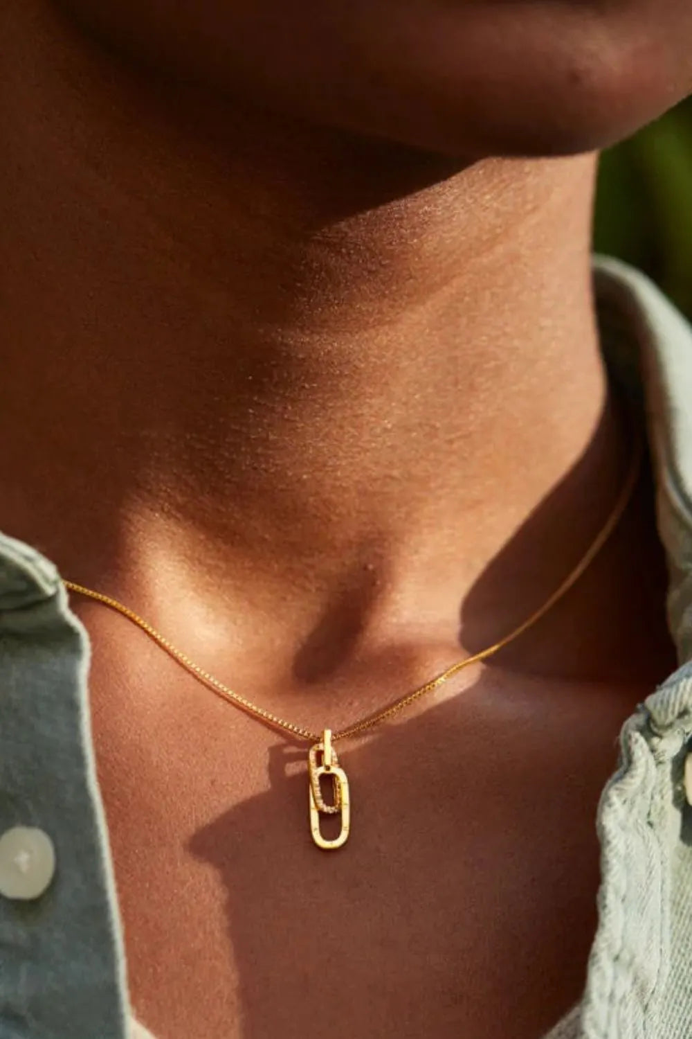 Gold linked pendant necklace with zirconia detail on a delicate chain