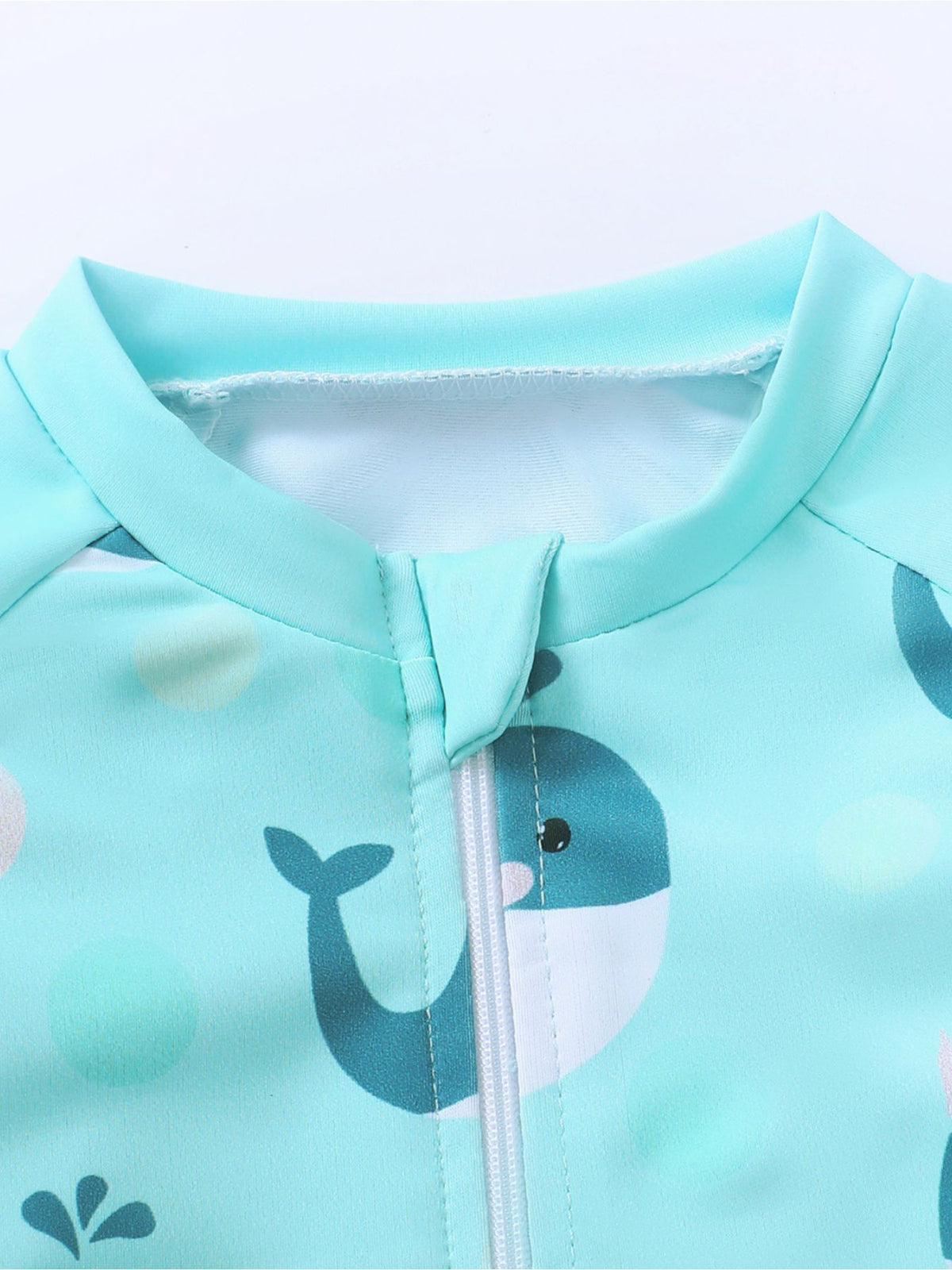 Children's turquoise swimwear set with whale print and zipper detail.