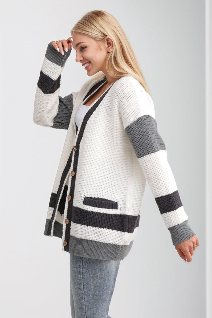 White waffle knit cardigan with grey and black stripes and long sleeves