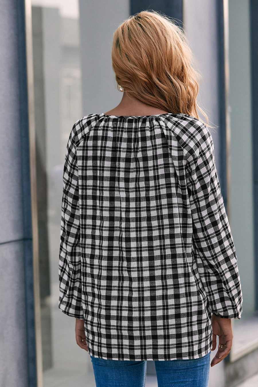 Black and white gingham blouse with gathered neckline and balloon sleeves.