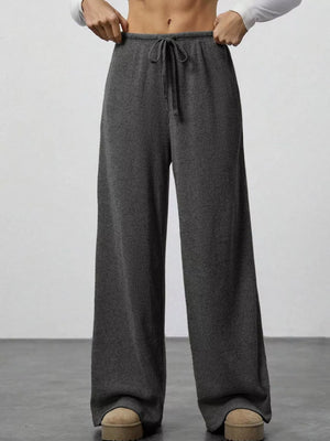 Dark gray ribbed wide-leg pants with drawstring waist and pockets.