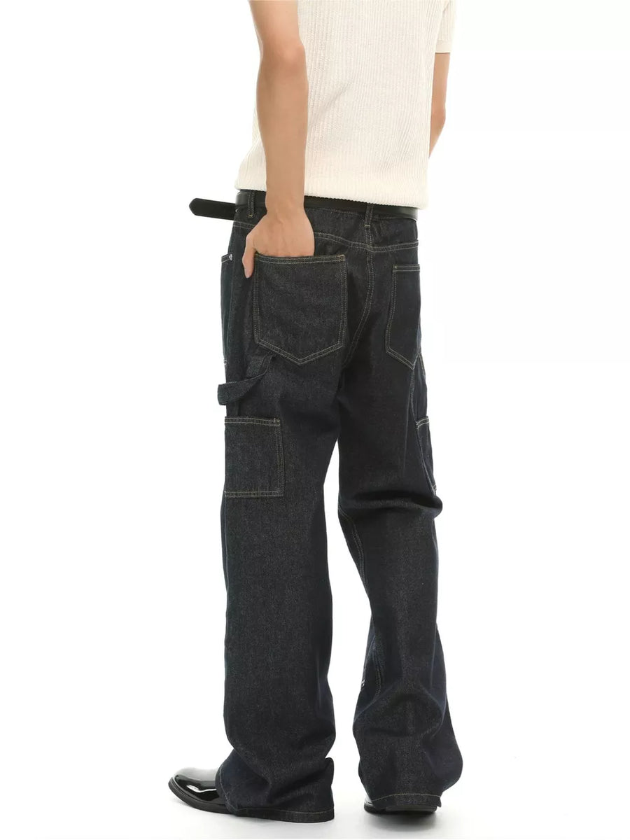 Dark wash cotton blend carpenter jeans with distinctive pockets and contrast stitching.