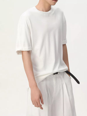 White cotton t-shirt with crew neck and cuffed short sleeves.