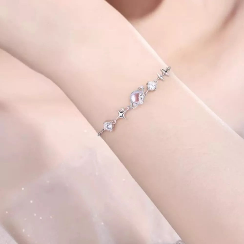 Celestial Zircon Star Adjustable Bracelet with clear and pink stones on a silver chain.